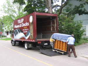 Unloading Upright Piano from Piano moving truck